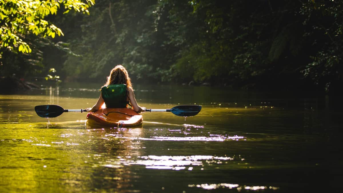 24 Pros And Cons Of Living In Costa Rica in 2025 12 Woman-Holding-Paddle-of-Kayak-on-Drake-Bay