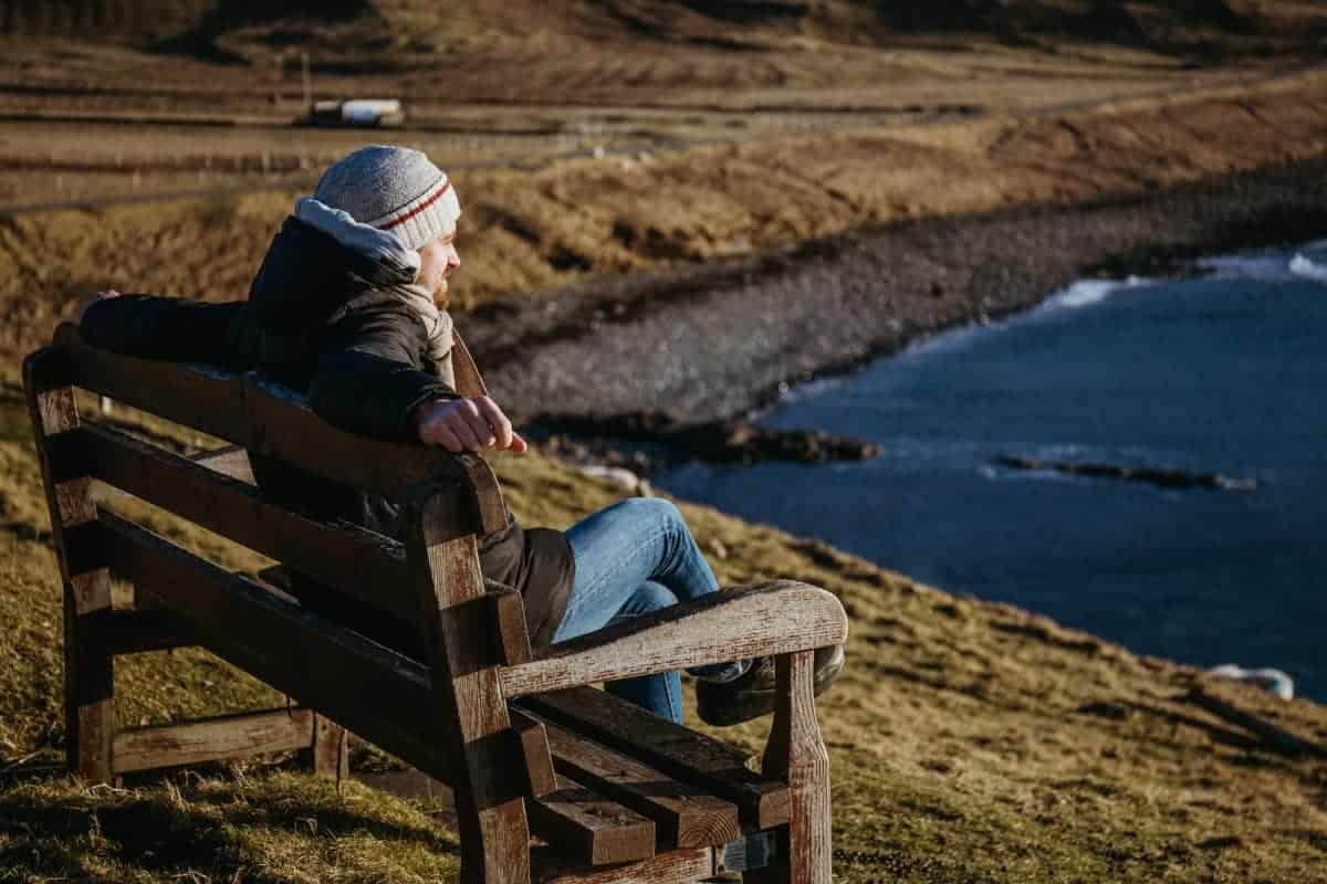 Man-Relaxing-on-a-Wooden-Bench