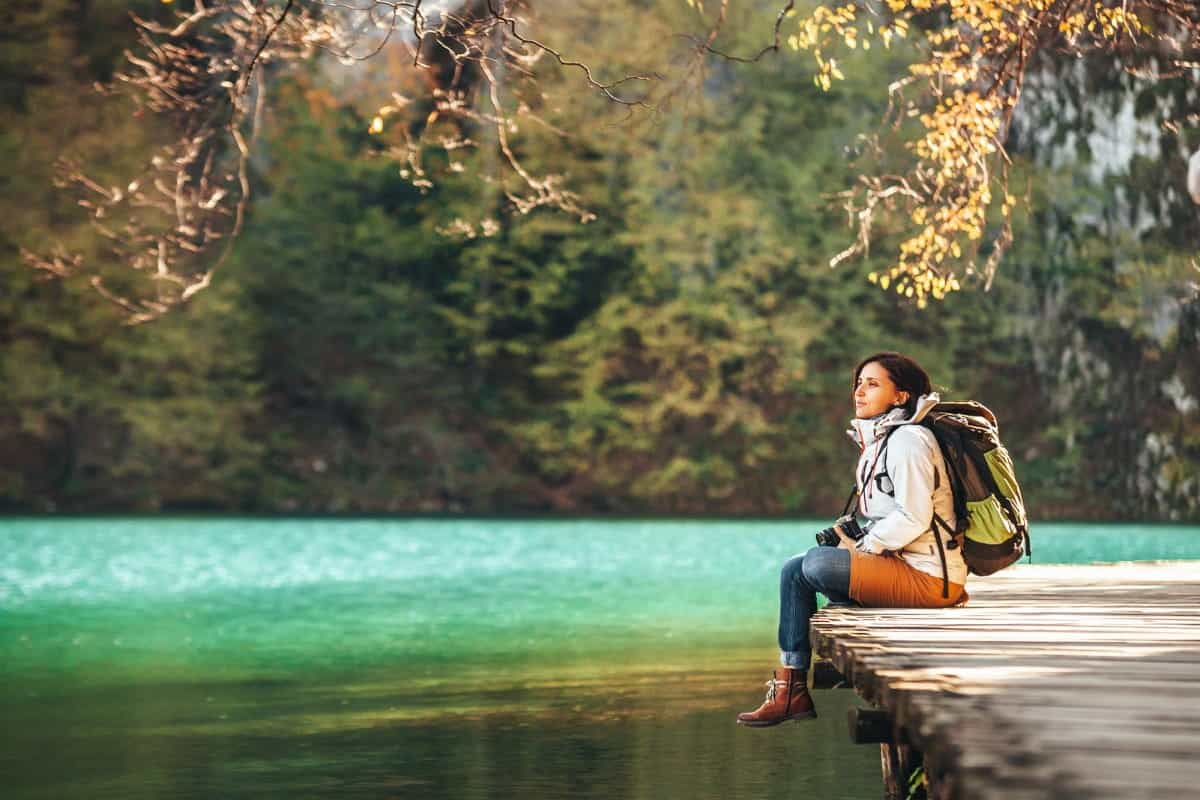 Woman-Sits-Wooden-Bridge