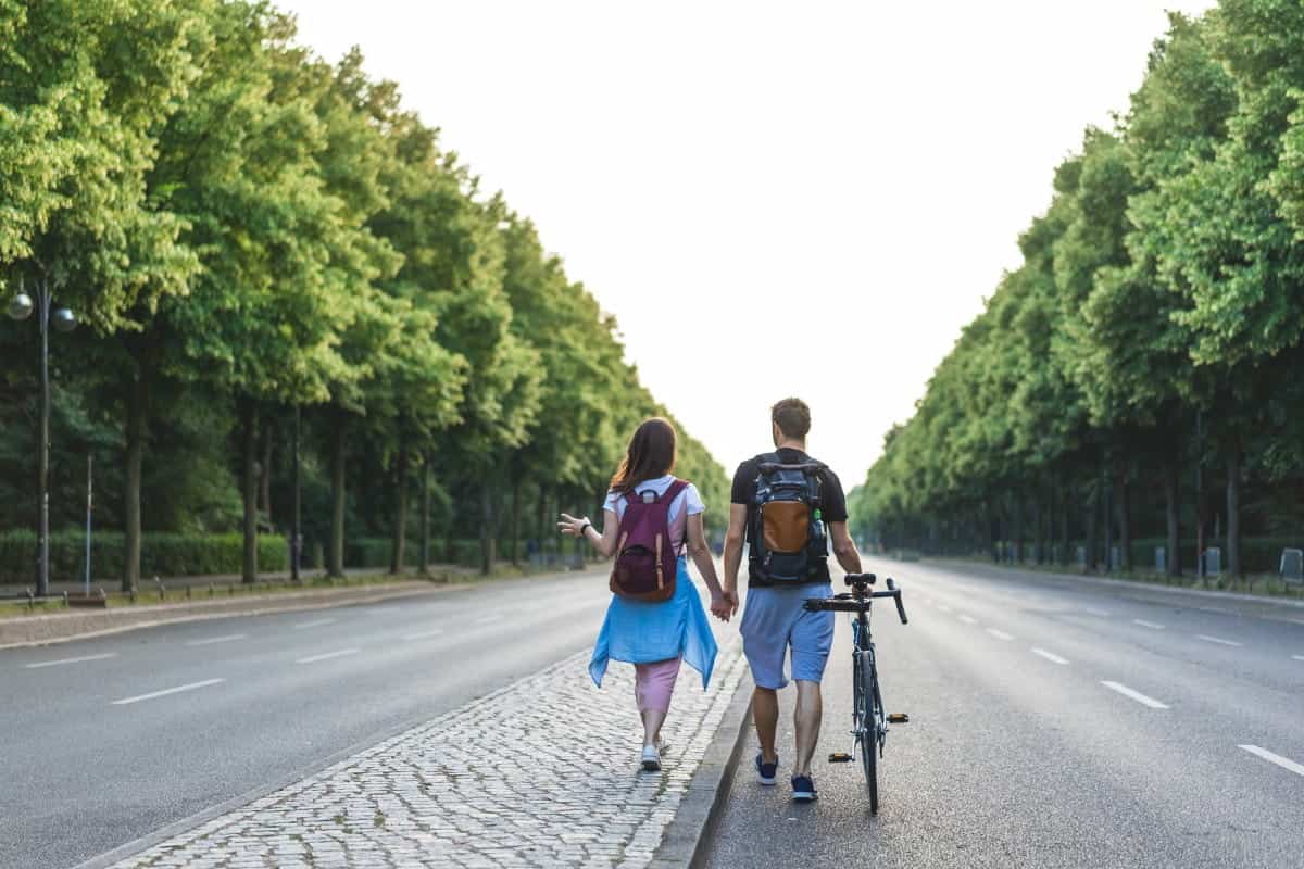A-Couple-with-Backpacks-&-Bicycle-in-Berlin