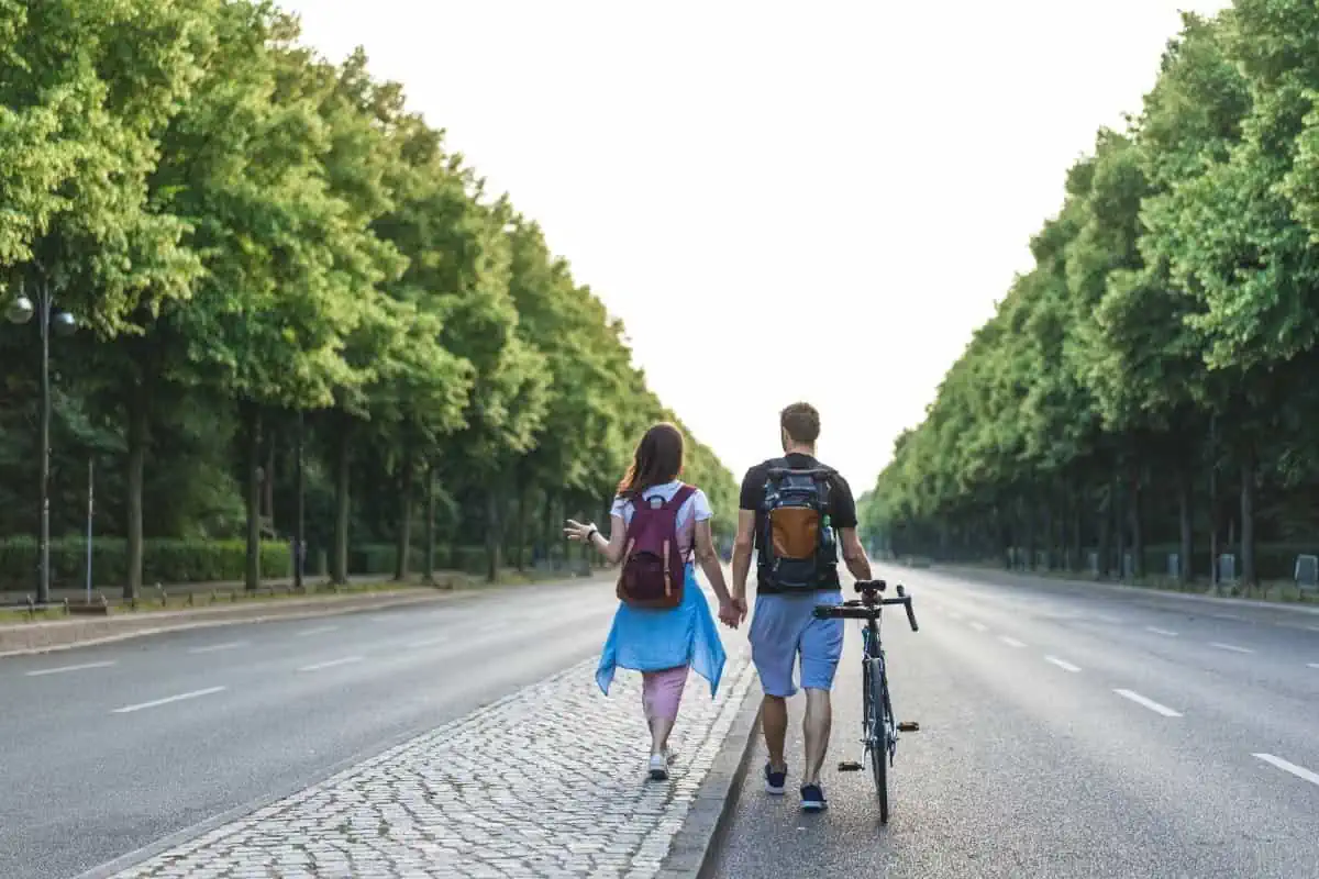 A-Couple-with-Backpacks-&-Bicycle-in-Berlin