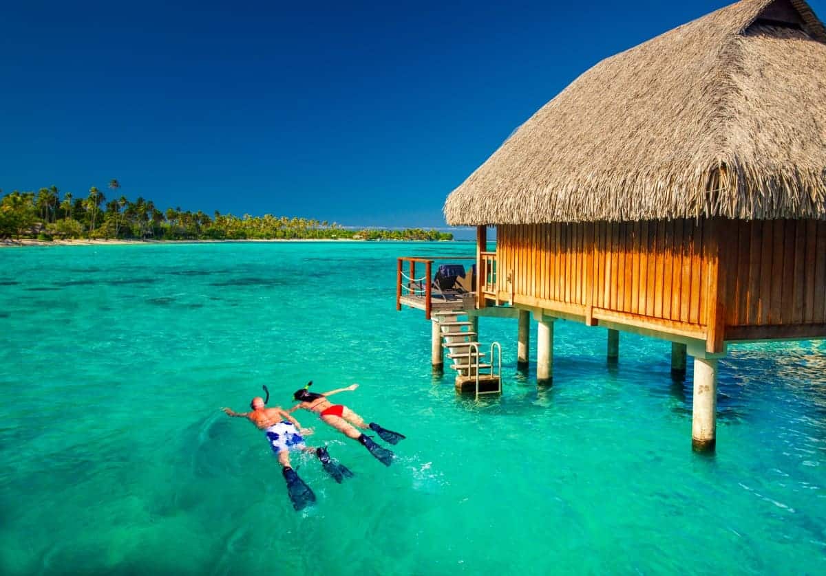 The 10 Best Overwater Bungalows In Tahiti (2025 Guide) 12 Couple-Snorkeling-Outside-Villa