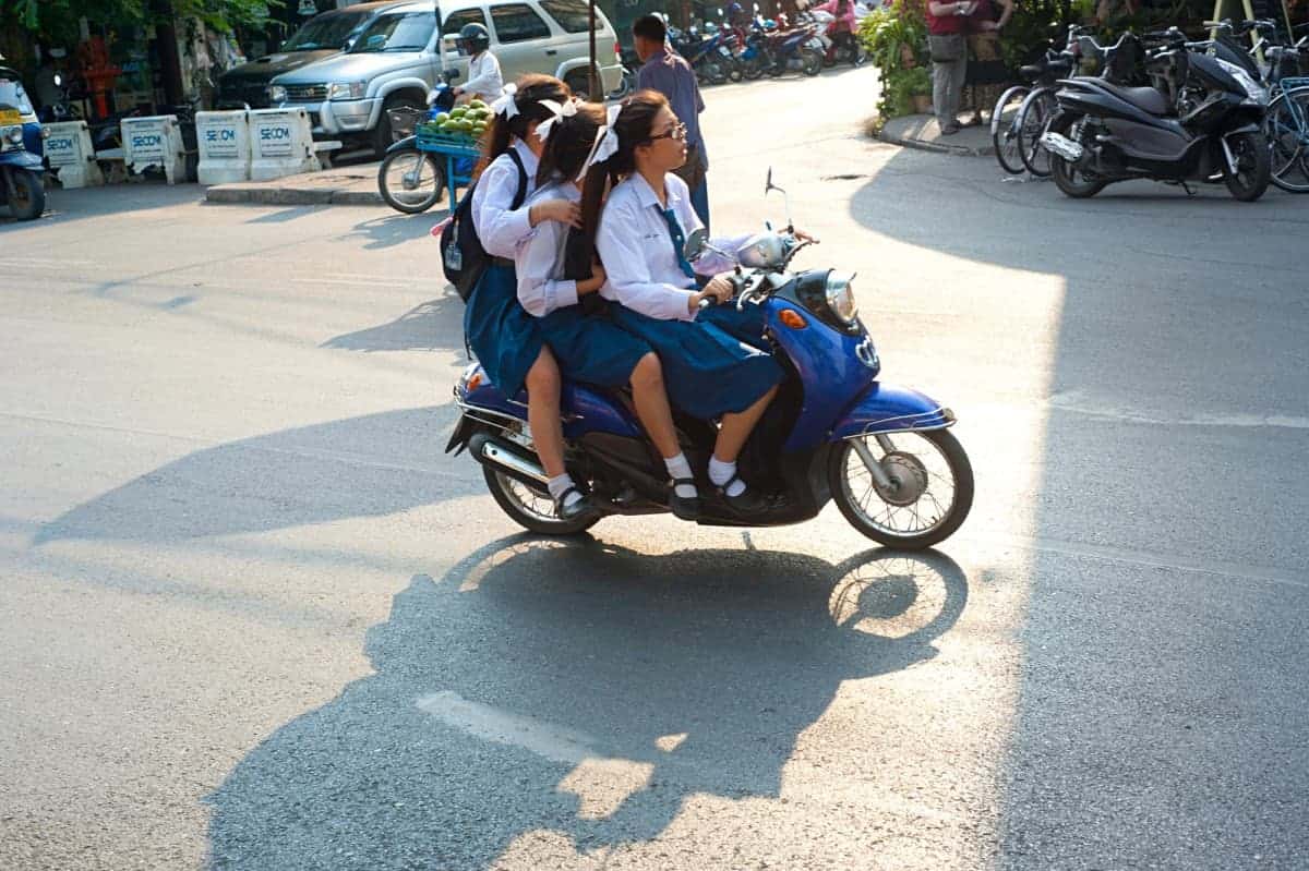 Schoolgirls-Riding-a-Motorbike-at-Chiang-Mai-Road