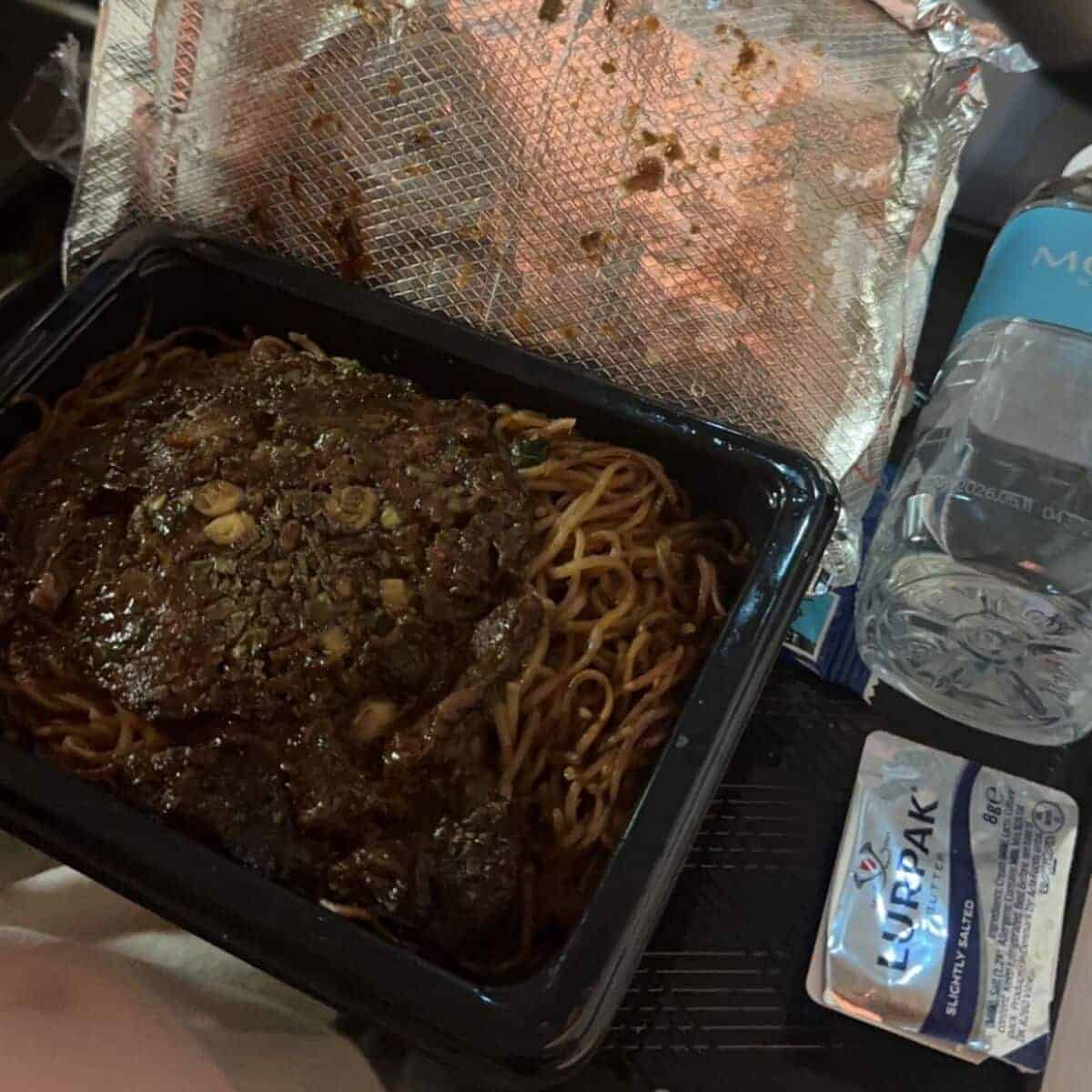30+ Things To Do on a Plane - On-the-Go Amusements 11 A-Person-Eating-Noodles-in-a-Airplane