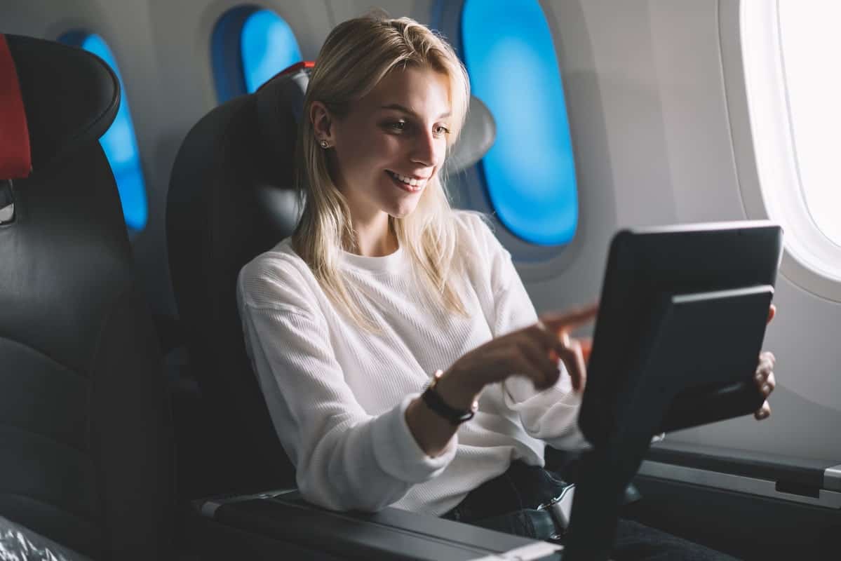 30+ Things To Do on a Plane - On-the-Go Amusements 3 A-Woman-Watching-TV-in-Plane