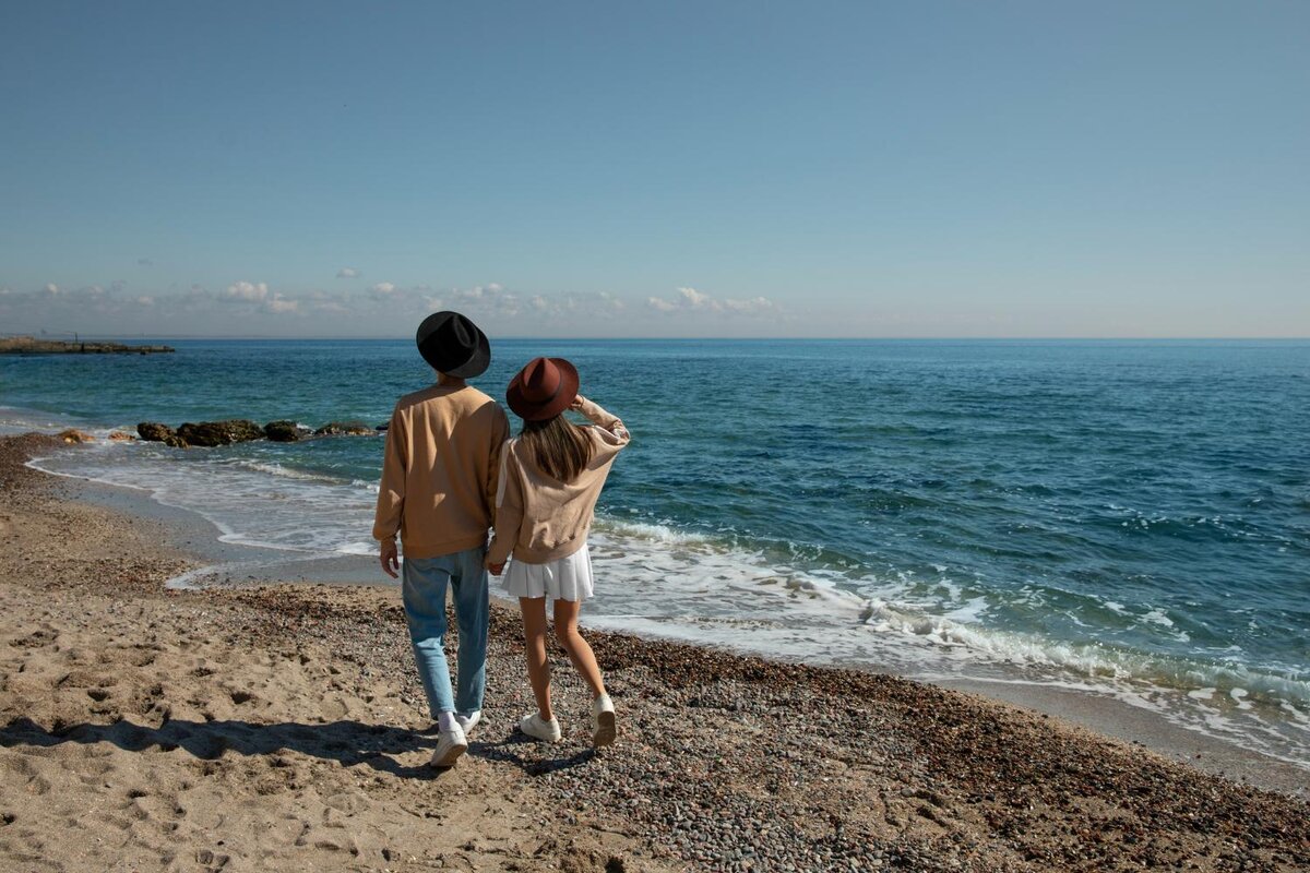 couple walking on beach in crete